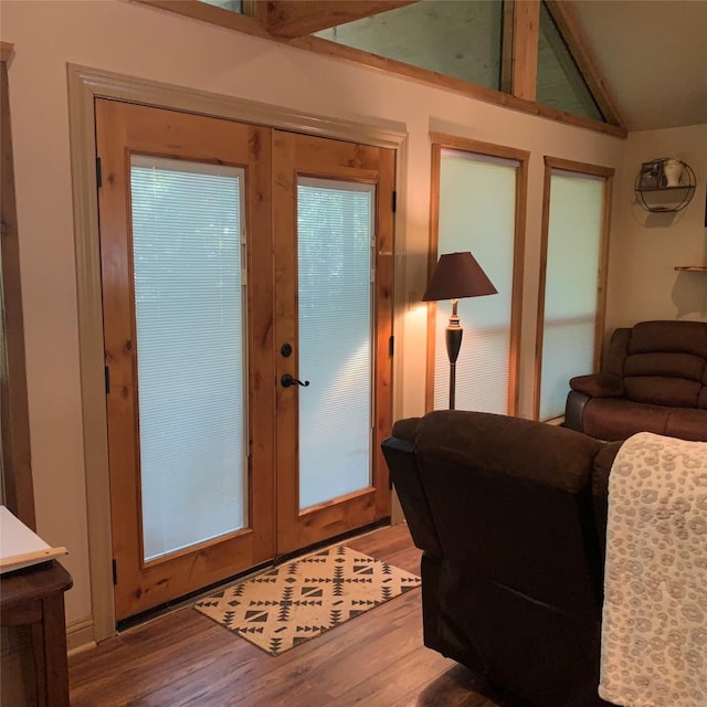 doorway with french doors, lofted ceiling, and hardwood / wood-style flooring