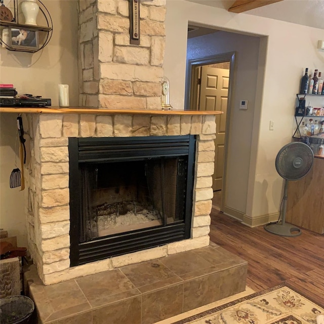 interior details with hardwood / wood-style flooring and a stone fireplace