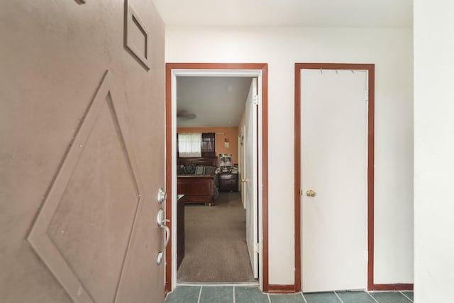 hallway featuring carpet flooring and visible vents