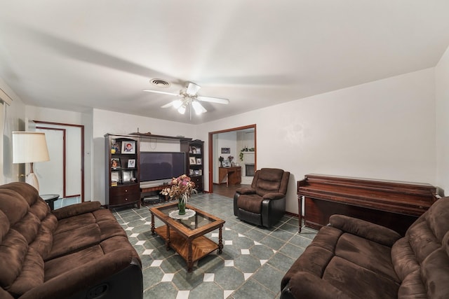 living area with visible vents and ceiling fan