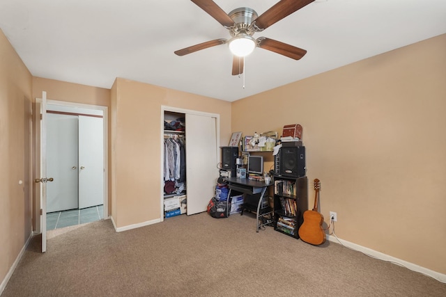 carpeted bedroom with a ceiling fan, a closet, and baseboards