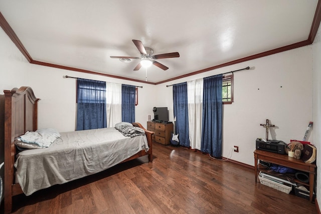 bedroom featuring ceiling fan, baseboards, wood finished floors, and crown molding