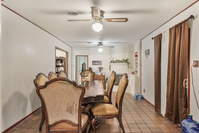 tiled dining room with visible vents, ceiling fan, and baseboards