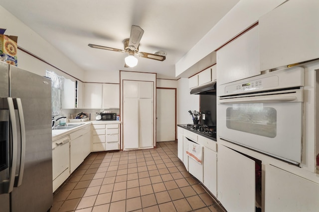 kitchen with light tile patterned floors, a ceiling fan, white cabinetry, under cabinet range hood, and black appliances