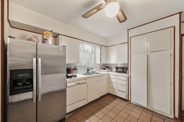 kitchen featuring stainless steel refrigerator with ice dispenser, light countertops, white dishwasher, a sink, and black microwave