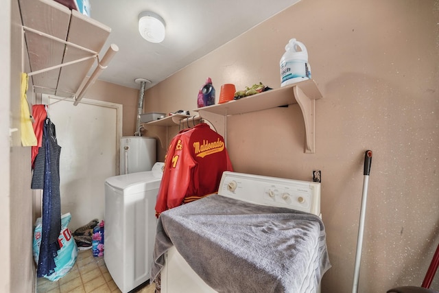 laundry area featuring laundry area, water heater, and washer and clothes dryer