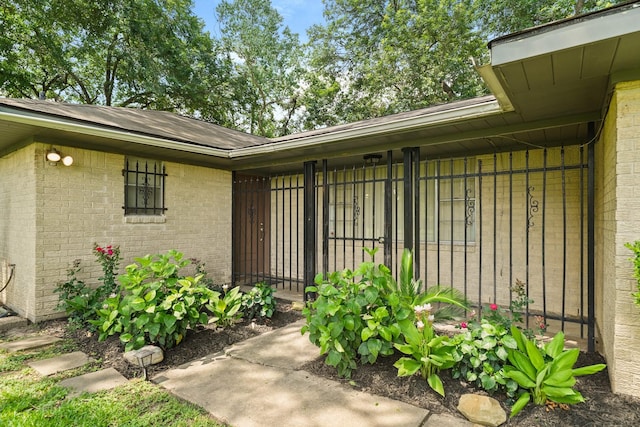 view of exterior entry with brick siding