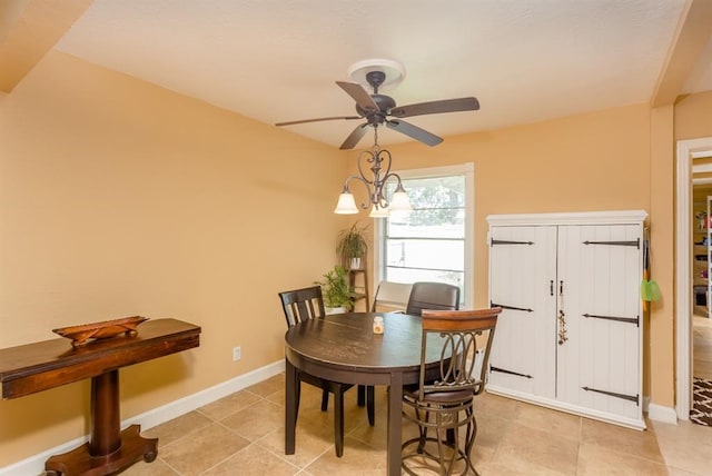 dining space with ceiling fan and light tile flooring