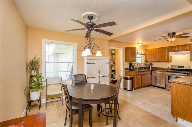 tiled dining space with sink and ceiling fan