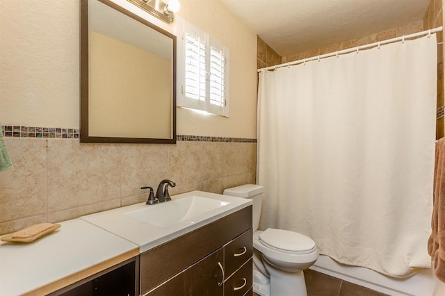 bathroom featuring tile flooring, tile walls, toilet, and vanity