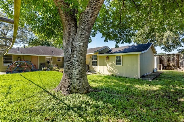 rear view of house featuring a yard