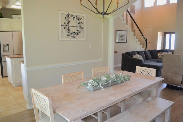 dining space featuring an inviting chandelier and ornate columns