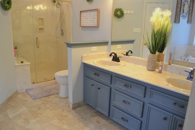 bathroom featuring vanity, toilet, and a shower with door