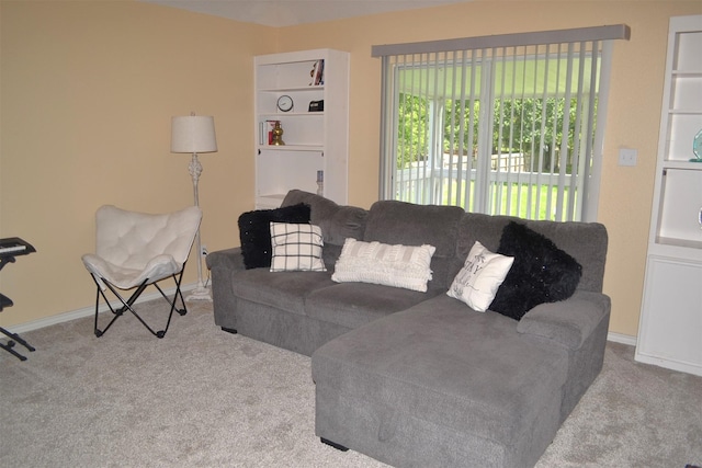 living room with built in features and light carpet