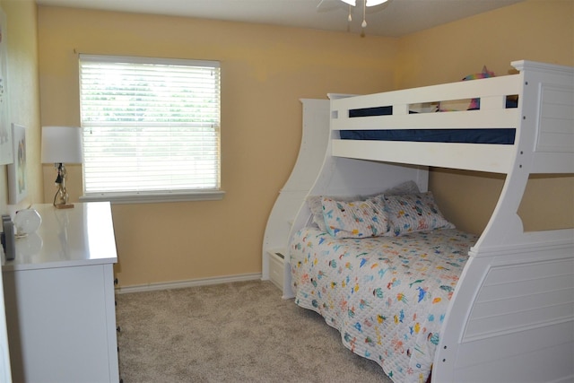 bedroom featuring light carpet and ceiling fan