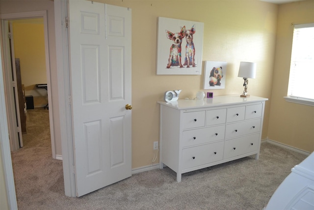 bedroom featuring light colored carpet