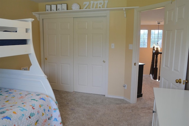 bedroom with light colored carpet and a closet