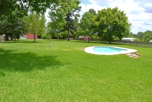 view of swimming pool featuring a lawn