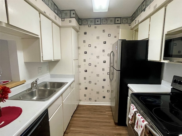 kitchen with dishwasher, white cabinets, sink, dark hardwood / wood-style floors, and electric range oven