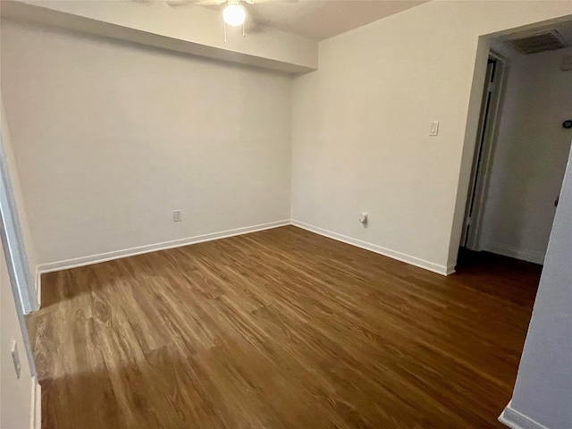 spare room with ceiling fan and dark hardwood / wood-style floors