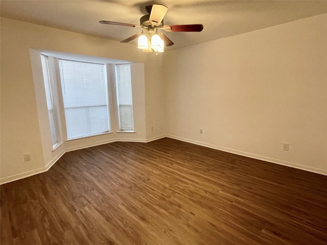 unfurnished room featuring ceiling fan and dark wood-type flooring