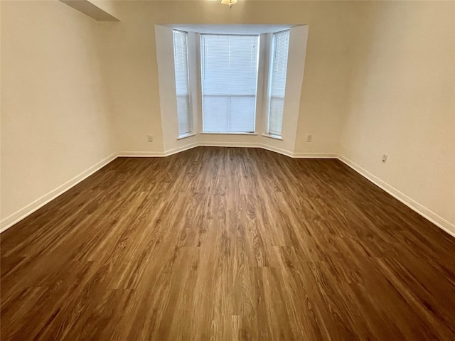 empty room featuring dark wood-type flooring