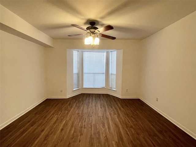 unfurnished room featuring dark hardwood / wood-style flooring and ceiling fan