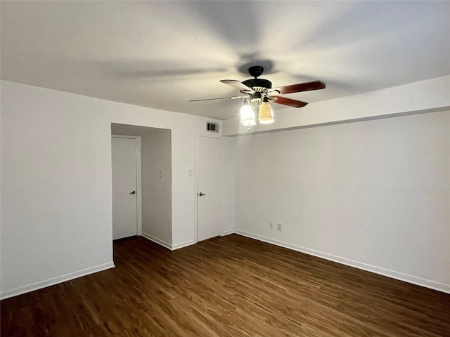 spare room featuring dark hardwood / wood-style floors and ceiling fan