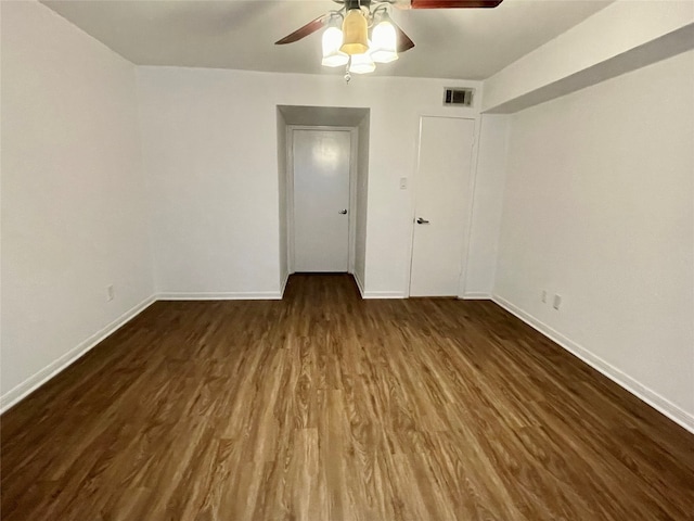 spare room featuring dark hardwood / wood-style flooring and ceiling fan