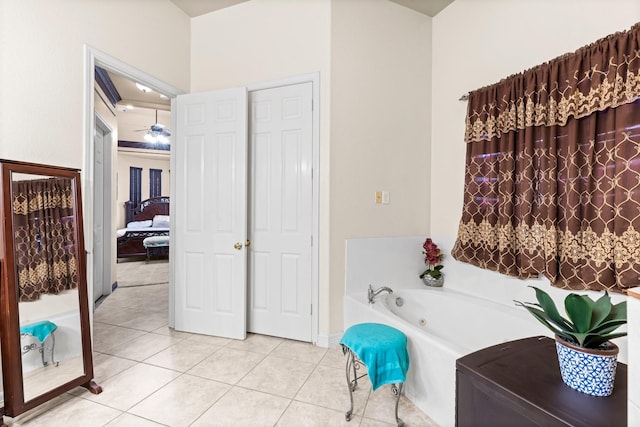 bathroom with a bath, tile patterned flooring, and ceiling fan