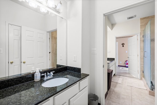 bathroom featuring tile patterned floors and vanity