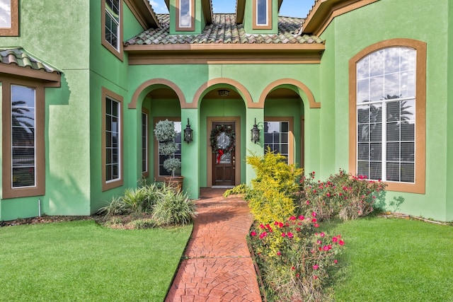 doorway to property with a yard