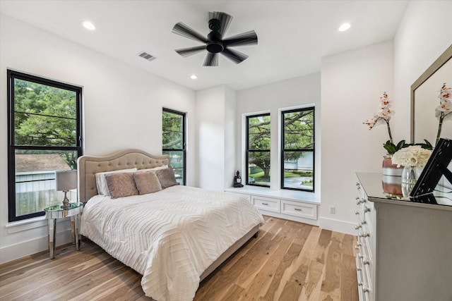 bedroom with ceiling fan and light hardwood / wood-style flooring