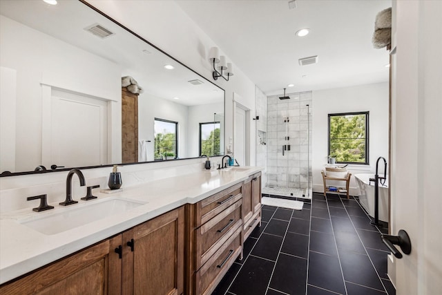 bathroom with vanity, tile patterned flooring, and plus walk in shower