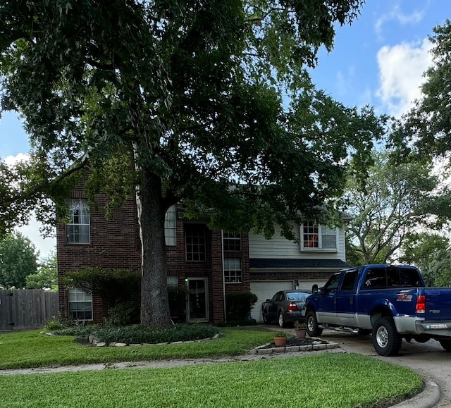 view of front of home with a garage and a front yard