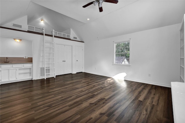 unfurnished bedroom featuring dark wood-type flooring, ceiling fan, lofted ceiling, and sink