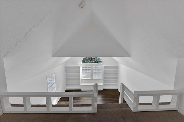 additional living space featuring lofted ceiling