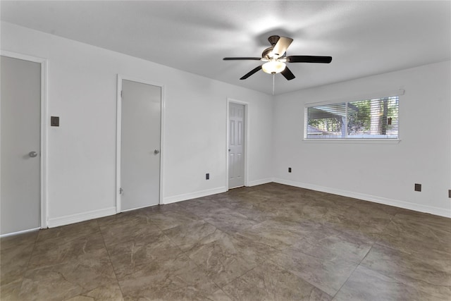 unfurnished bedroom featuring multiple closets and ceiling fan