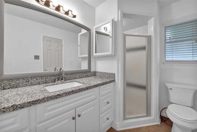 bathroom with vanity, toilet, an enclosed shower, and tile patterned flooring