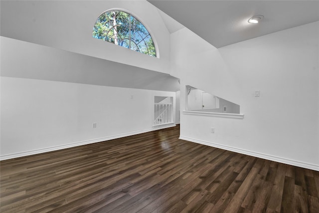 unfurnished living room with lofted ceiling and dark hardwood / wood-style flooring