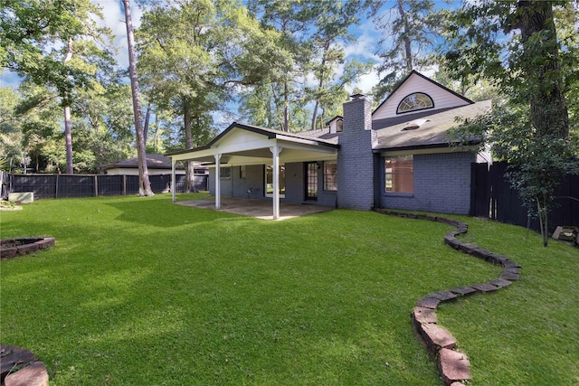 view of front of house with a front yard and a patio area