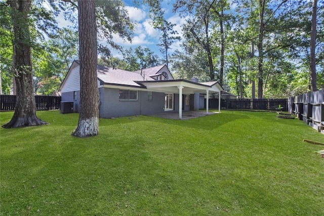 view of yard featuring central AC unit and a patio