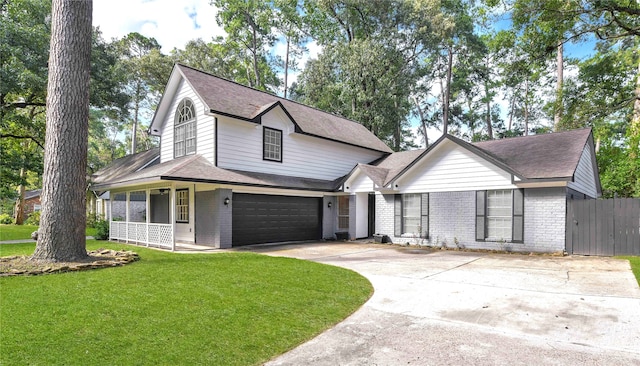 view of front facade featuring a garage, a front yard, and covered porch