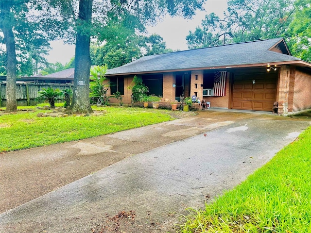 view of front of house featuring a front yard, cooling unit, and a garage