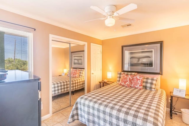 bedroom with crown molding, a closet, ceiling fan, and light tile patterned flooring