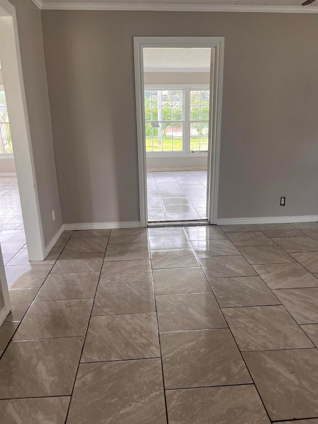 unfurnished room with tile patterned flooring and crown molding