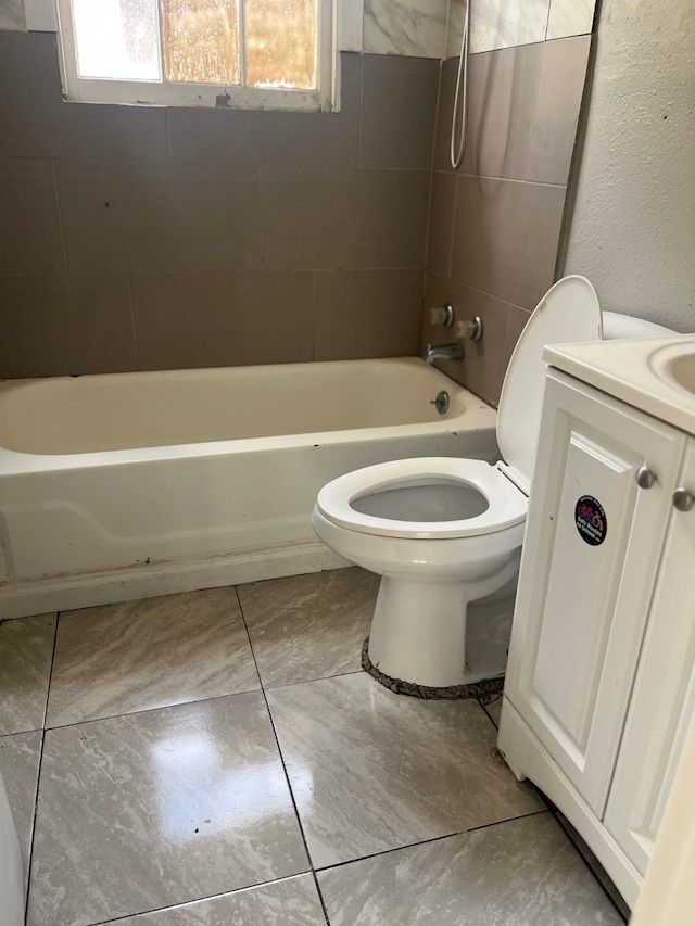 full bathroom with vanity, toilet, and tiled shower / bath