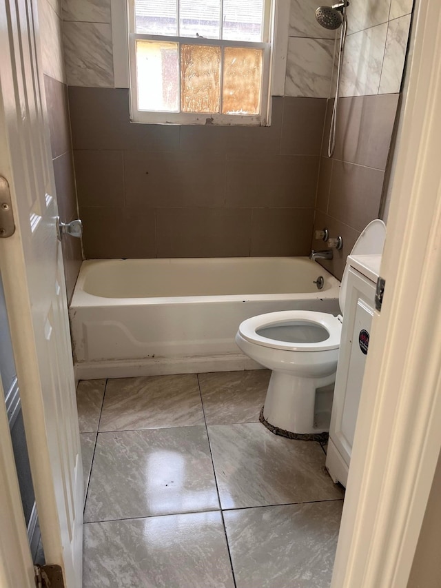 bathroom with tiled shower / bath combo and toilet