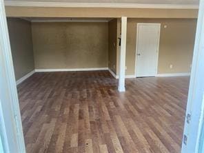 interior space with ornamental molding and dark wood-type flooring