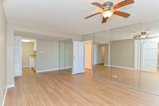 unfurnished bedroom with ceiling fan, light wood-type flooring, and ensuite bathroom